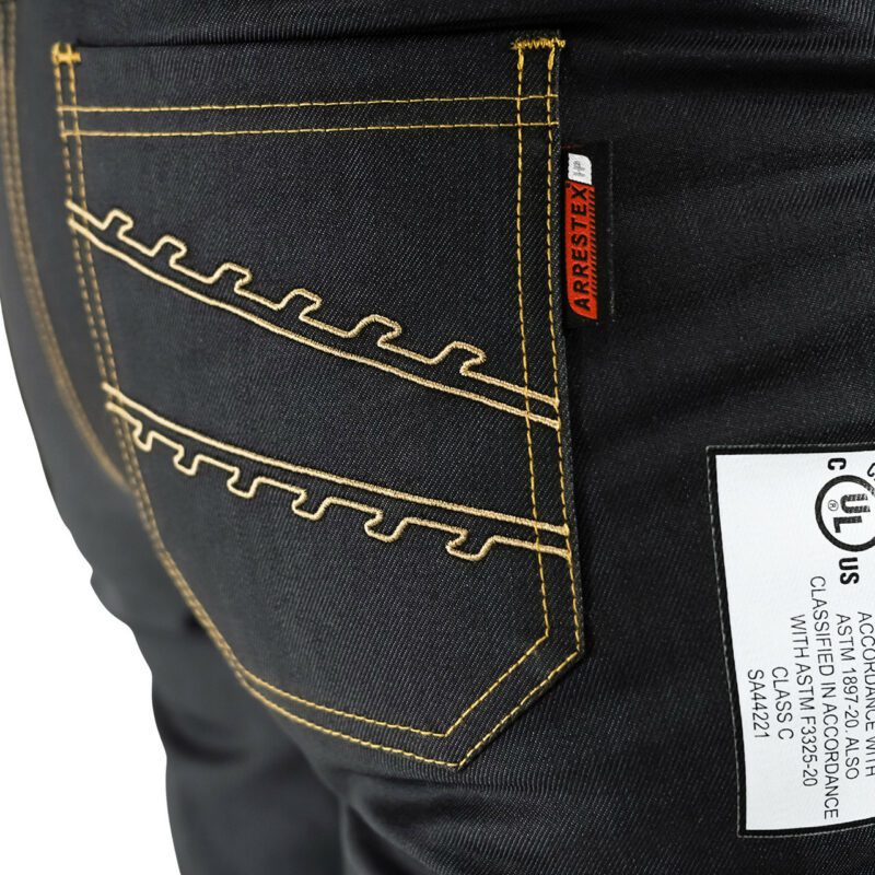 Arborist Wearing Clogger Denim Chainsaw Pants While Climbing